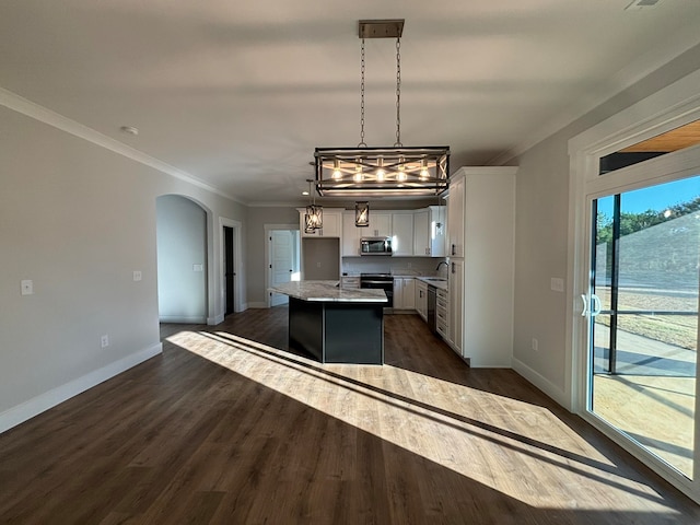 kitchen featuring sink, a kitchen island, dark hardwood / wood-style flooring, hanging light fixtures, and white cabinets