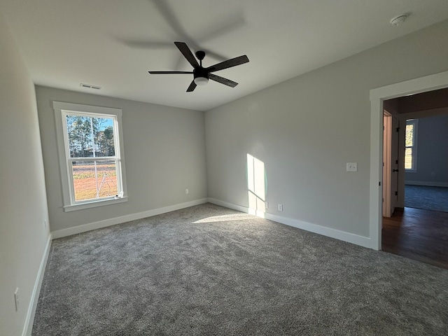 carpeted spare room featuring ceiling fan