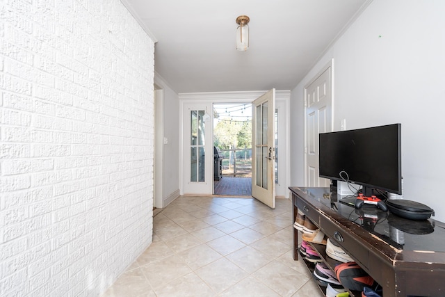 interior space with ornamental molding and french doors