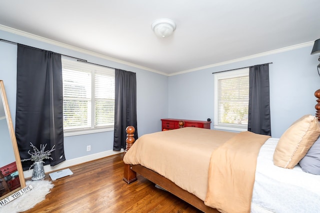 bedroom with ornamental molding and dark hardwood / wood-style flooring