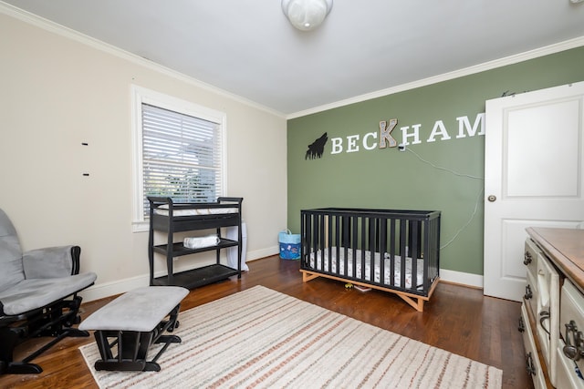 bedroom featuring ornamental molding, dark hardwood / wood-style flooring, and a nursery area