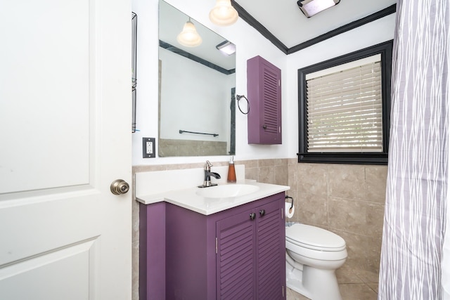 bathroom with vanity, toilet, and tile walls