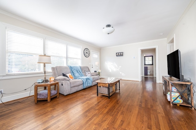 living room featuring ornamental molding, a healthy amount of sunlight, and dark hardwood / wood-style flooring