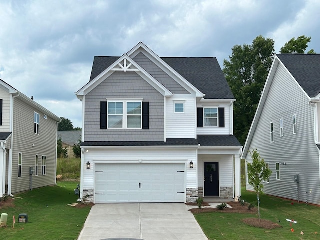 craftsman-style house with a garage and a front lawn