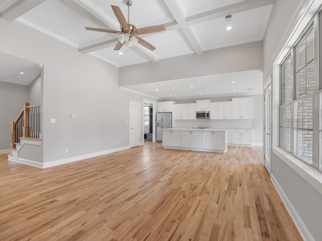 unfurnished living room with crown molding, light hardwood / wood-style flooring, and a healthy amount of sunlight