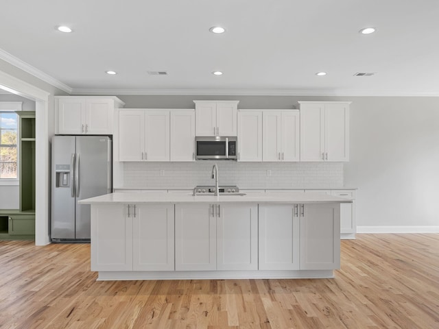 kitchen featuring light hardwood / wood-style floors, white cabinets, and stainless steel appliances