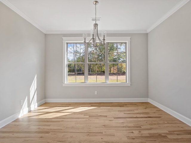 unfurnished dining area with a notable chandelier, light hardwood / wood-style floors, and crown molding