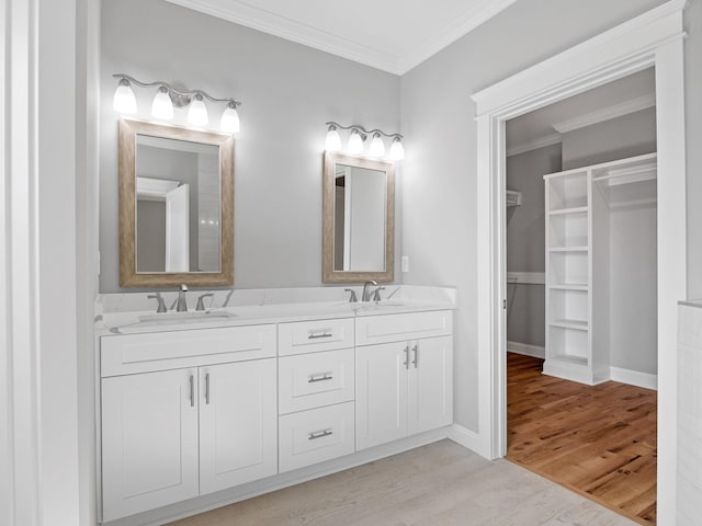 bathroom featuring vanity, hardwood / wood-style floors, and ornamental molding