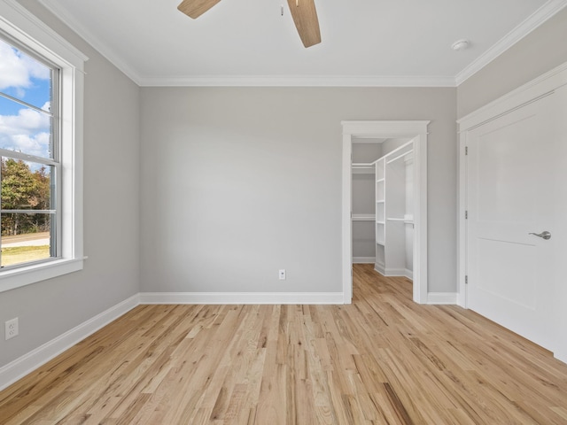 unfurnished bedroom with light hardwood / wood-style floors, multiple windows, crown molding, and ceiling fan