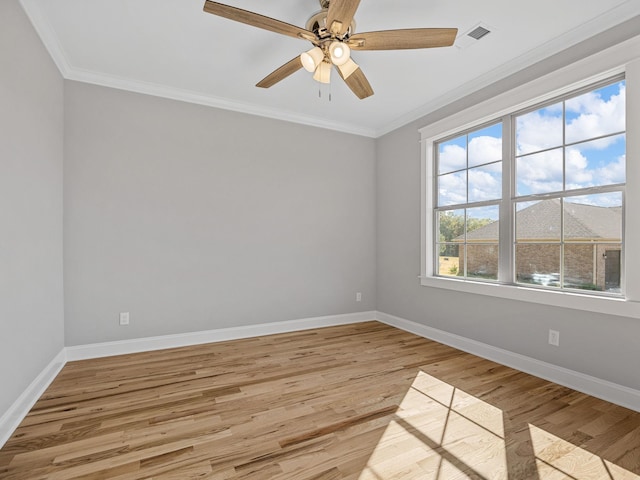 unfurnished room featuring ornamental molding, light wood-type flooring, and ceiling fan