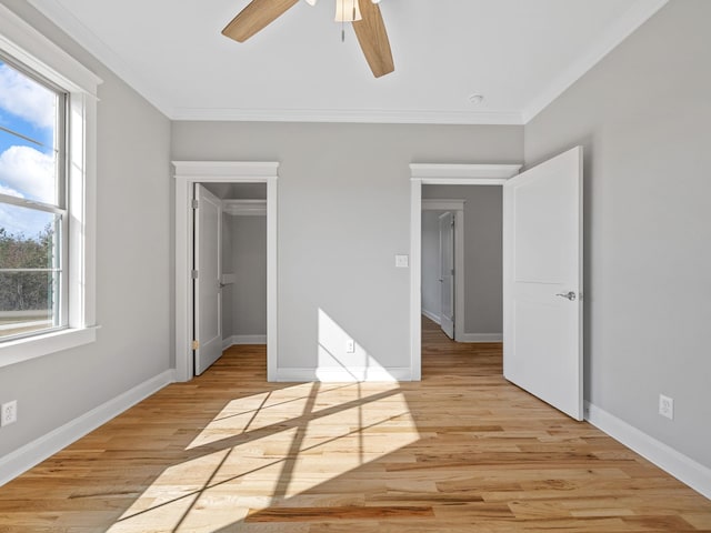 unfurnished bedroom with a closet, ceiling fan, crown molding, and light wood-type flooring