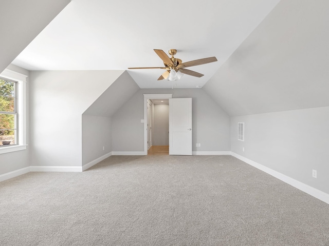 bonus room with vaulted ceiling, carpet floors, and ceiling fan