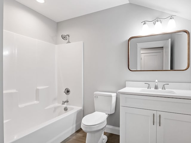 full bathroom with vanity, tub / shower combination, vaulted ceiling, and toilet