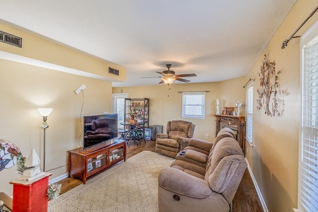 living room featuring hardwood / wood-style floors and ceiling fan