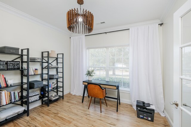 office area with crown molding and light wood-type flooring