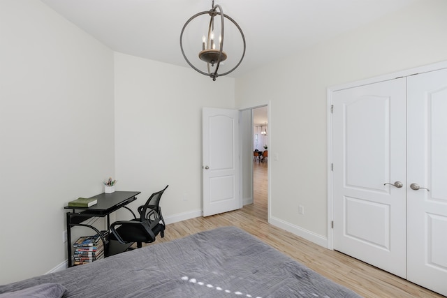 office space with light hardwood / wood-style flooring and a notable chandelier