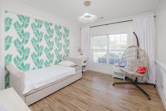 bedroom featuring light hardwood / wood-style floors and crown molding