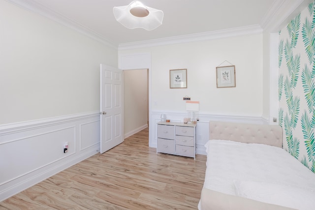 bedroom with ornamental molding and light wood-type flooring