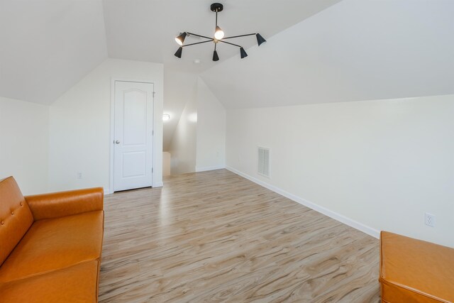 bonus room with light hardwood / wood-style floors and lofted ceiling