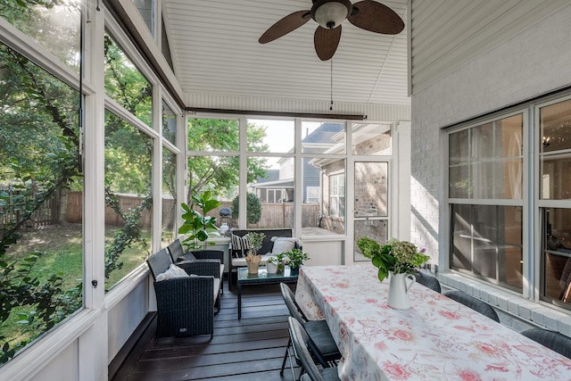 sunroom / solarium featuring lofted ceiling and ceiling fan