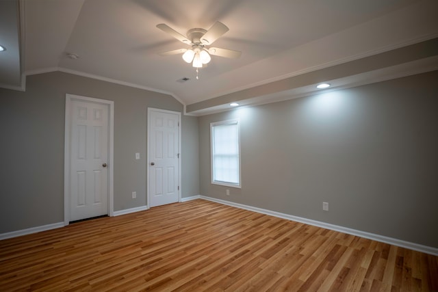 unfurnished bedroom featuring light hardwood / wood-style floors, crown molding, vaulted ceiling, and ceiling fan