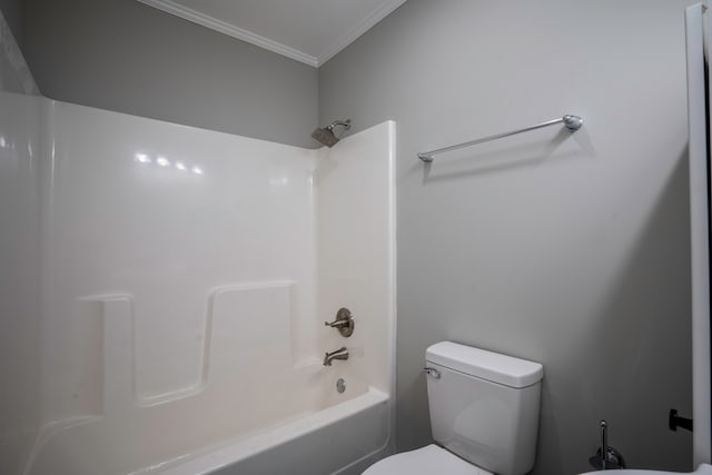 bathroom with toilet, crown molding, and shower / tub combination