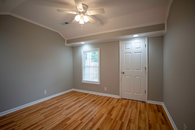 unfurnished room with ceiling fan, ornamental molding, vaulted ceiling, and light wood-type flooring