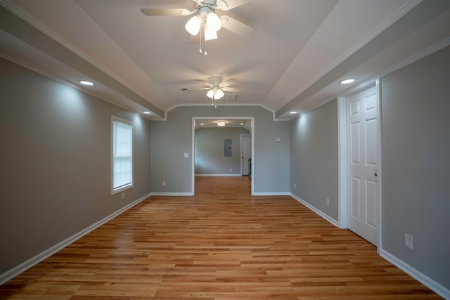 empty room with ceiling fan, ornamental molding, and light wood-type flooring