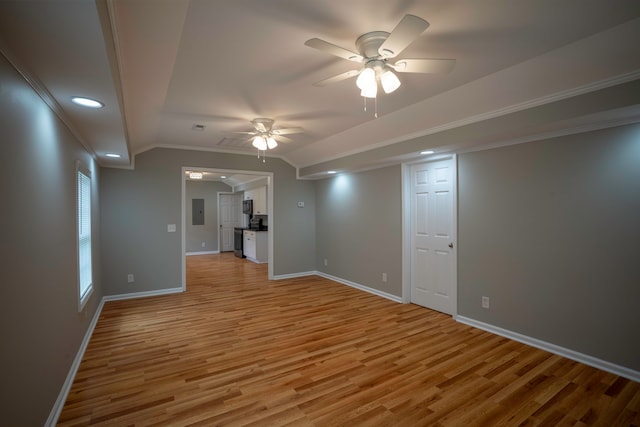 spare room featuring ornamental molding, electric panel, light hardwood / wood-style floors, and ceiling fan