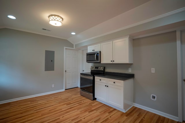 kitchen featuring lofted ceiling, white cabinets, electric panel, light wood-type flooring, and stainless steel appliances