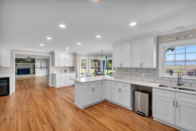 kitchen featuring a wealth of natural light, light wood-type flooring, and white cabinets