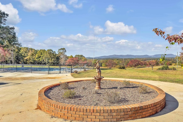 view of property's community featuring a mountain view and tennis court