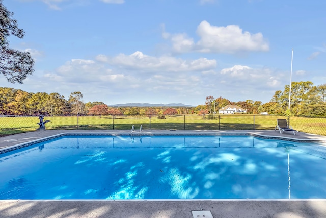 view of swimming pool with a mountain view