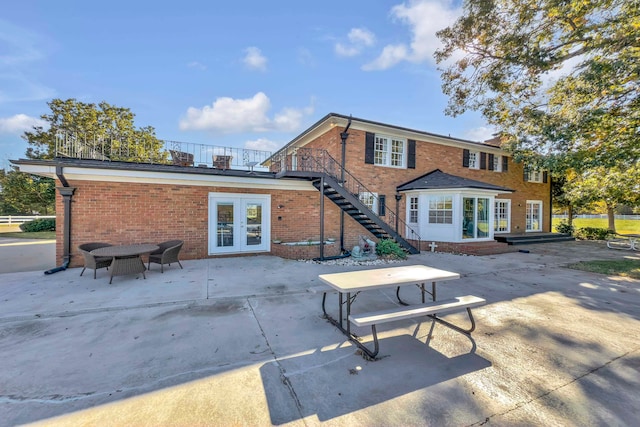 rear view of house with french doors and a patio area