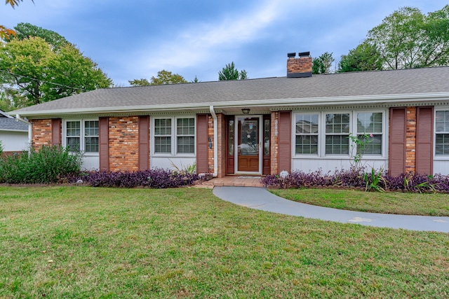 ranch-style house with a front lawn