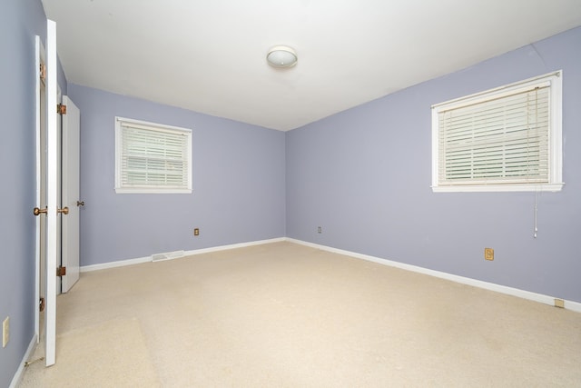 empty room featuring light carpet