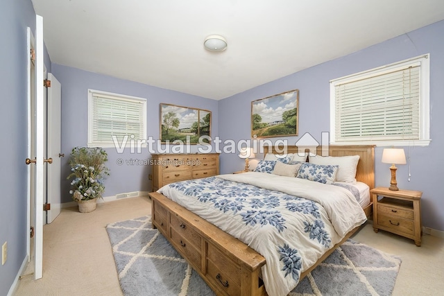 bedroom featuring light carpet