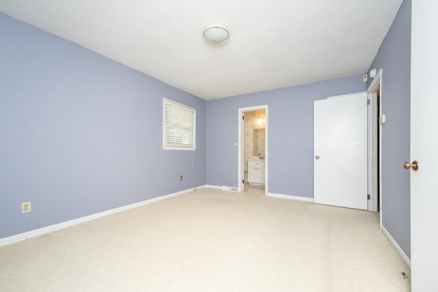 unfurnished bedroom with carpet and ensuite bath