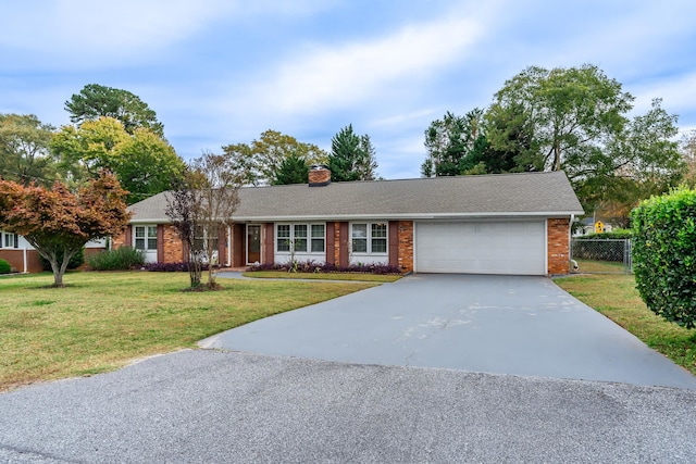 single story home with a front yard and a garage