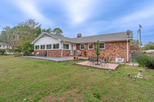 back of house with a patio and a yard