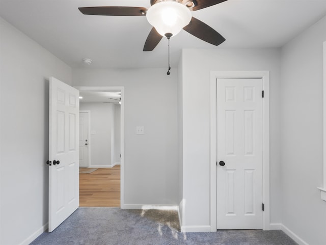 unfurnished bedroom with a closet, ceiling fan, and carpet floors