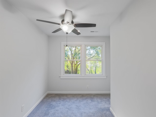 carpeted spare room featuring ceiling fan