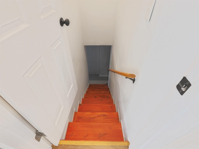 staircase with hardwood / wood-style floors