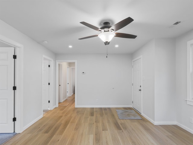 unfurnished room with ceiling fan and light wood-type flooring