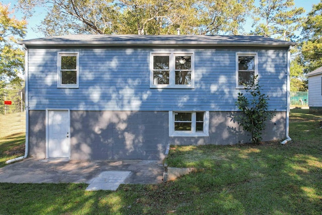 rear view of house with a yard