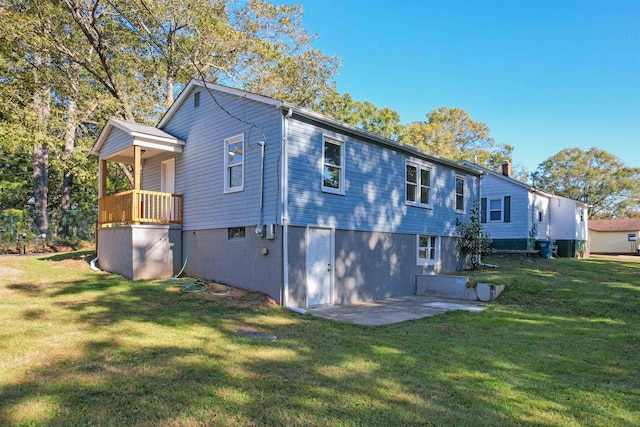 rear view of house featuring a patio area and a lawn