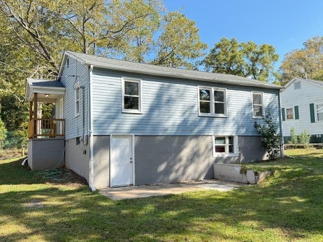 rear view of property with a yard