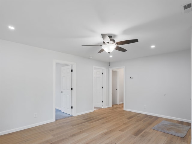 unfurnished room with light wood-type flooring and ceiling fan