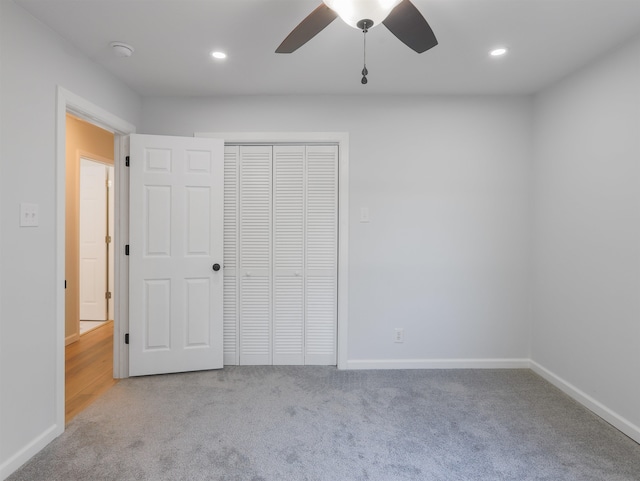 unfurnished bedroom featuring a closet, carpet flooring, and ceiling fan