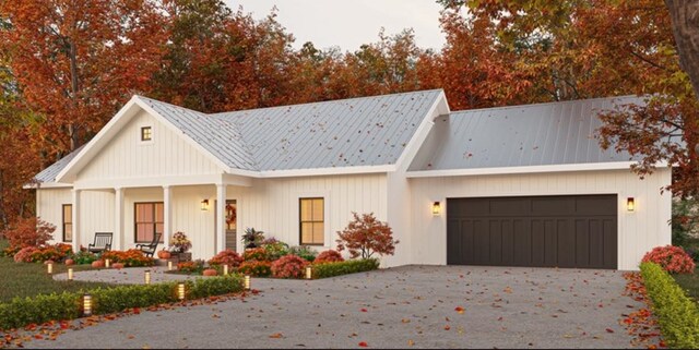 view of front of home featuring covered porch and a garage